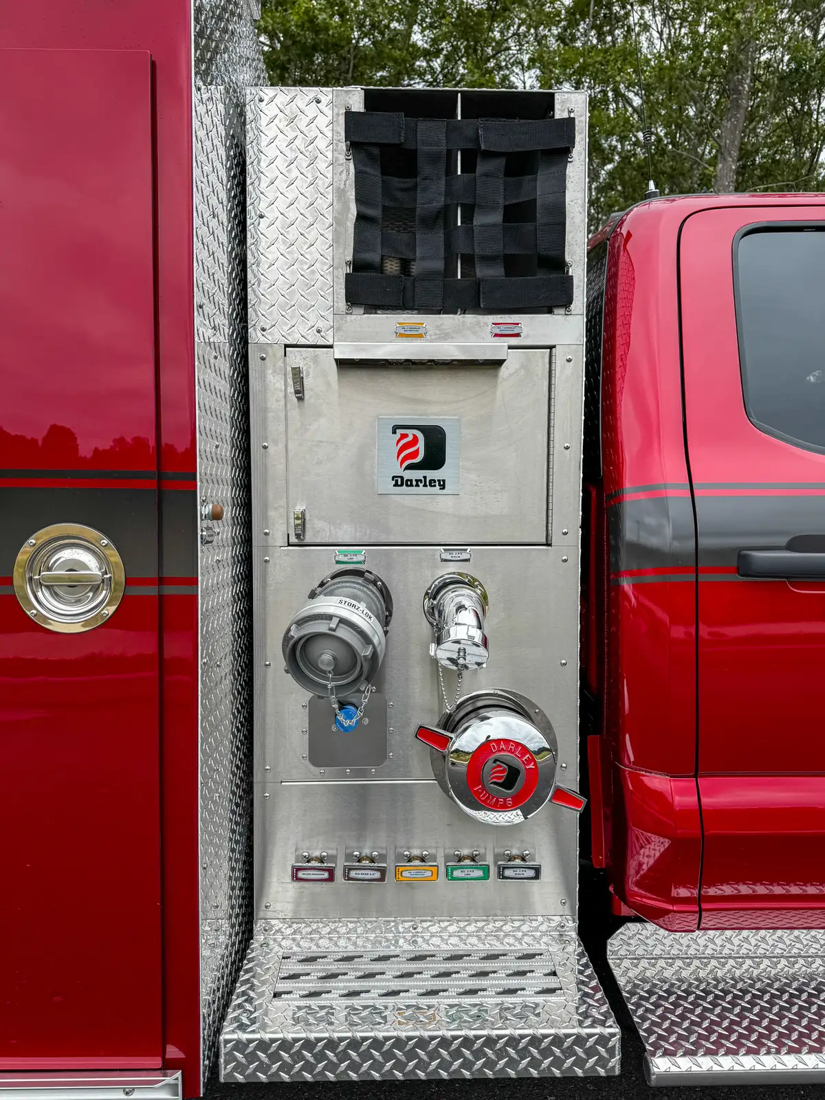 Pump panel close-up showing intake cap and discharge valve controls.